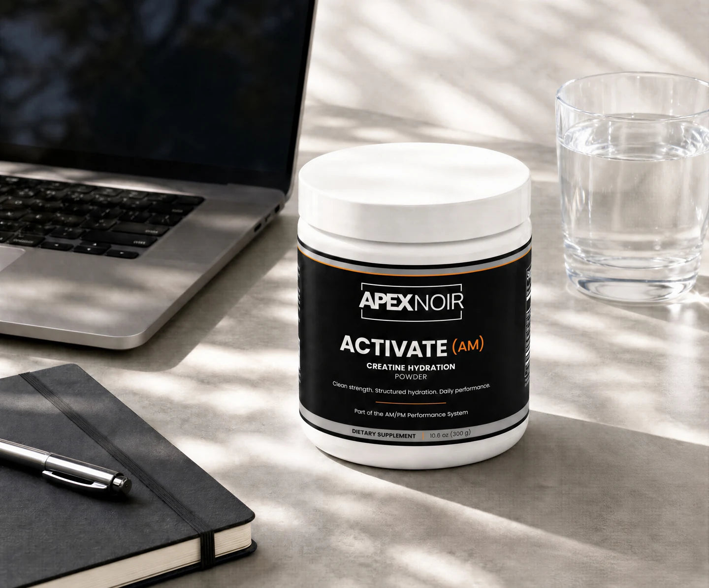ACTIVATE beside a laptop and water glass in a morning work routine
